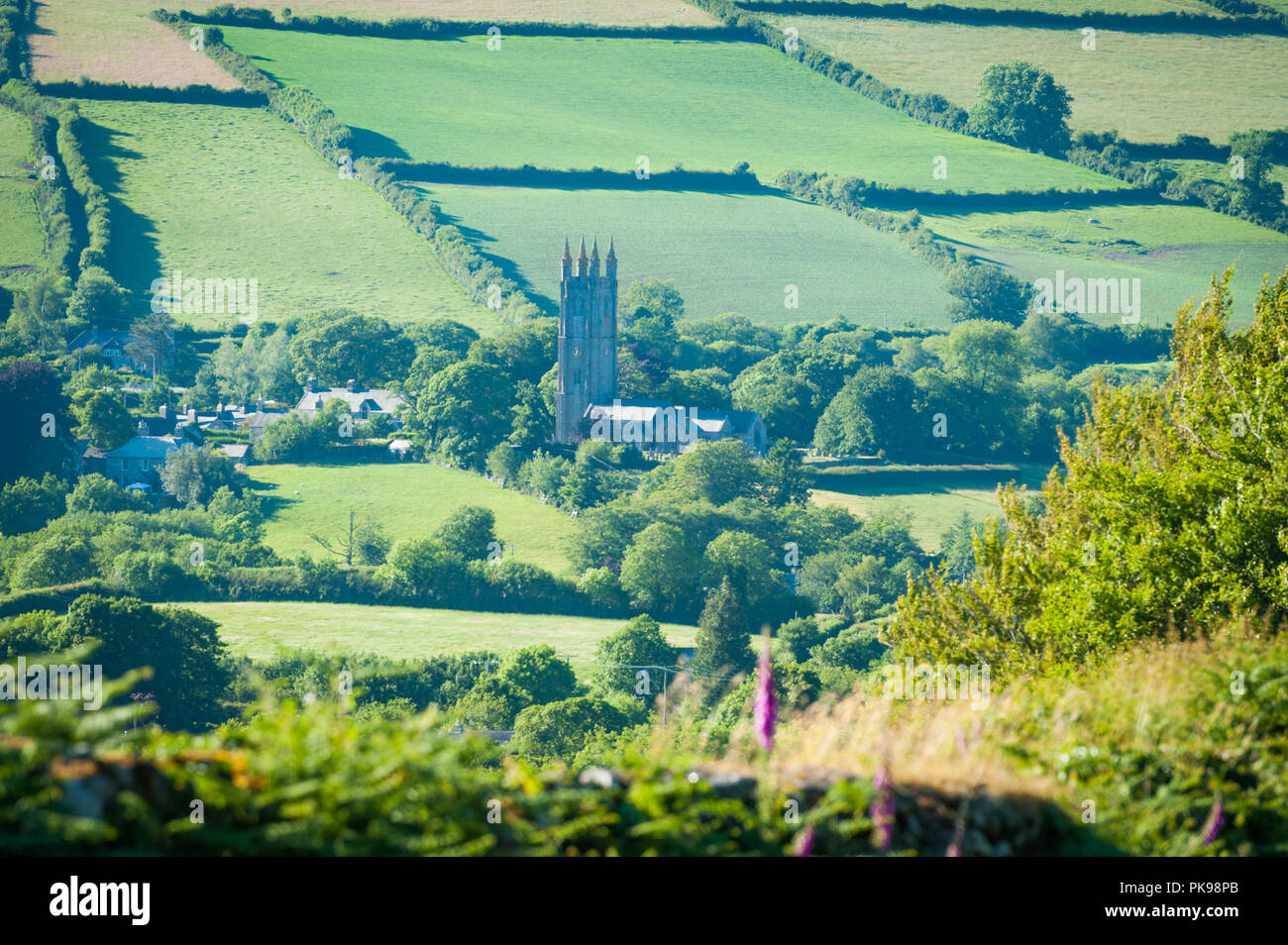 Distant view of traditional english church and village Stock Photo