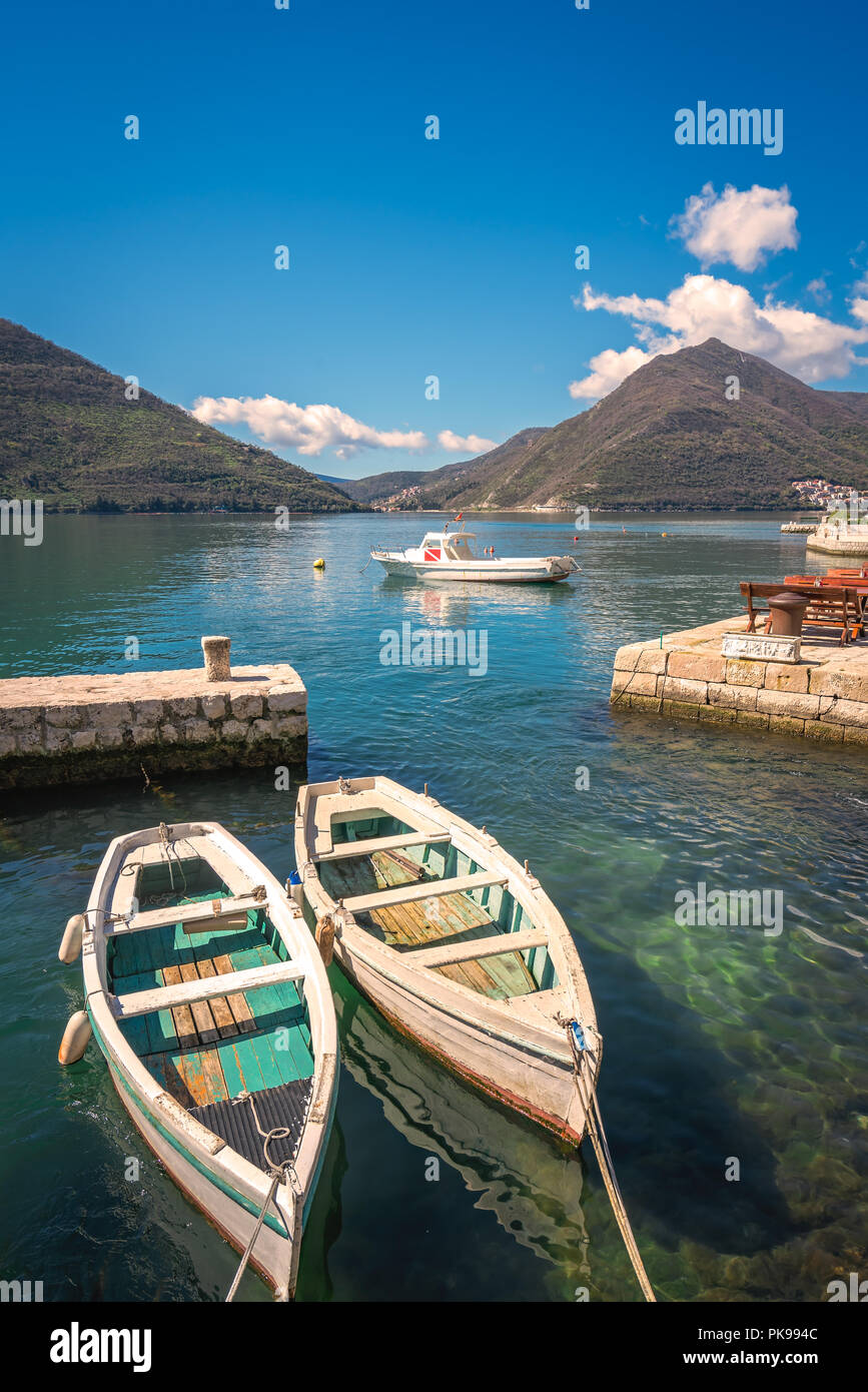 Two small fishing boats on the shore in the beautiful Perast town in