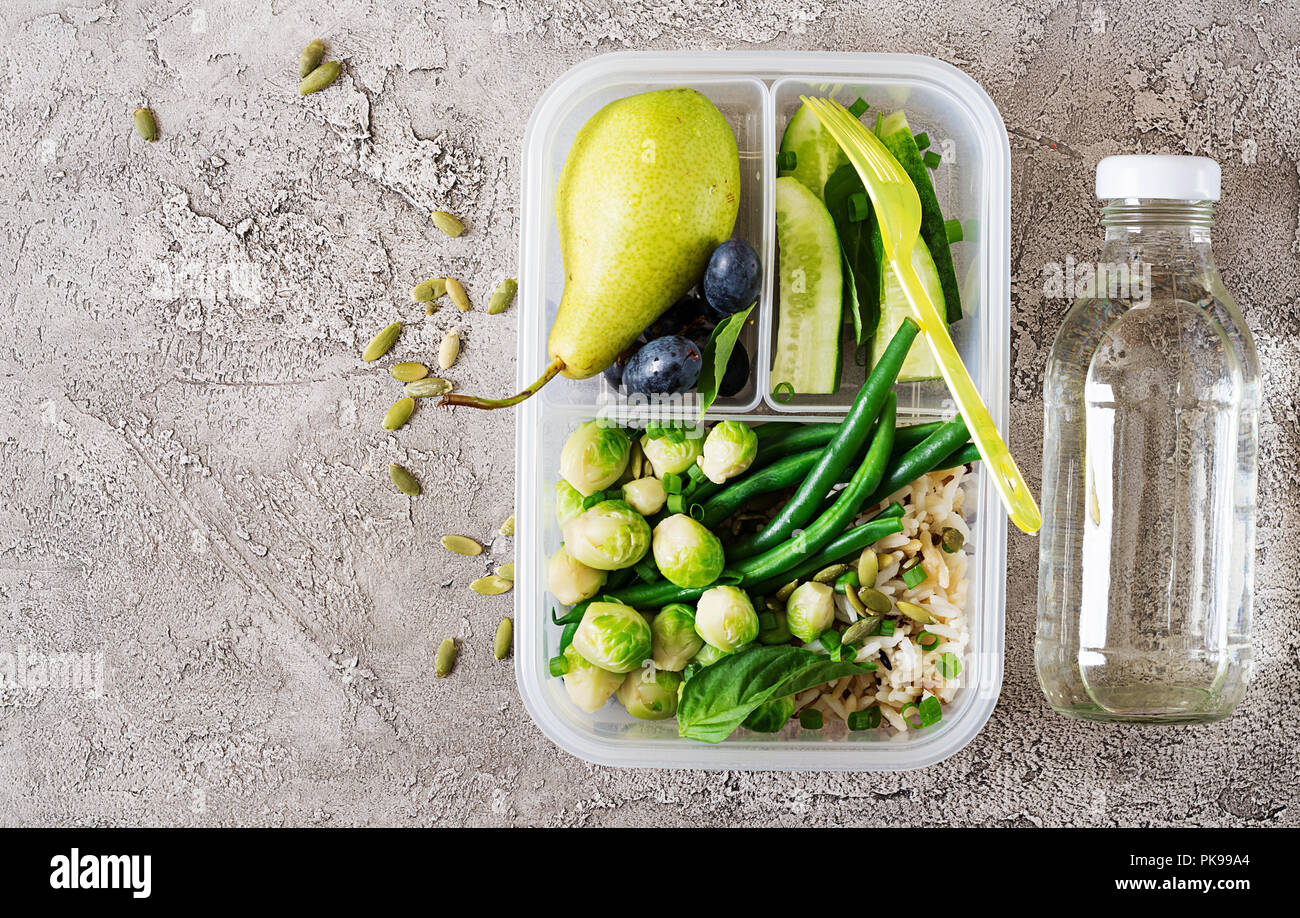 Vegan green meal prep containers with rice, green beans, brussel