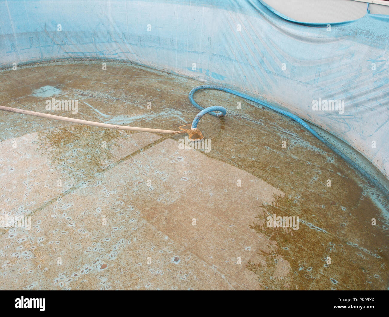 Bottom of dirty damaged swimming pool needs cleaning and repair Stock