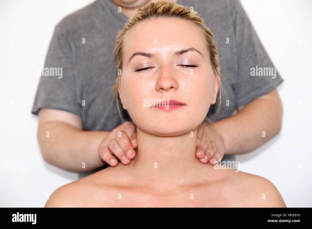 Massage relax studio. Woman having her neck massaged. Massage therapist