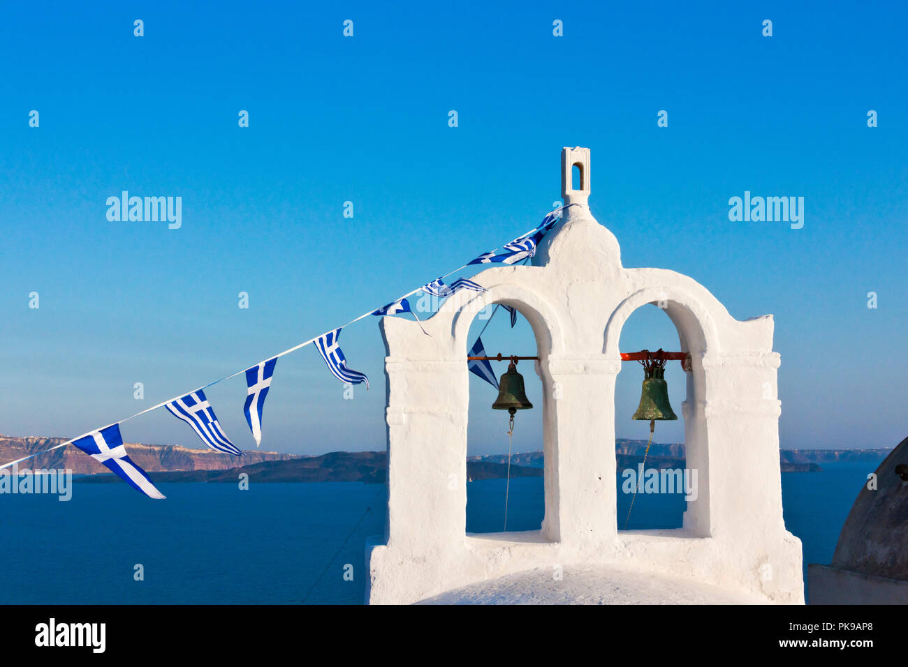 Church bell tower on the coast of Aegean Sea, Oia, Santorini Island, Greece Stock Photo