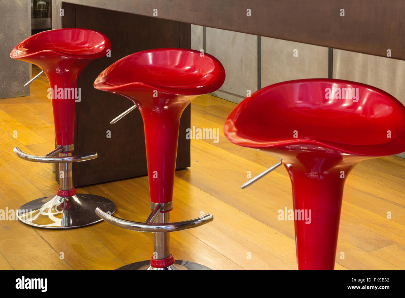 Interior of modern house, counter top with red stools, detail Stock Photo