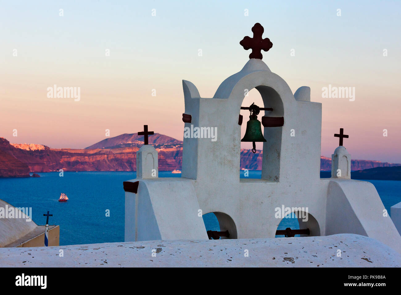 Church bell tower on the coast of Aegean Sea, Oia, Santorini Island, Greece Stock Photo