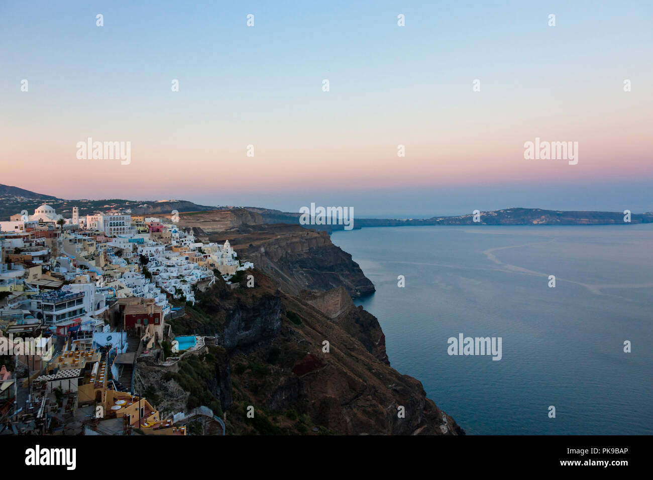 Houses perched on the cliff on the coast of Aegean Sea, Fira, Santorini Island, Greece Stock Photo