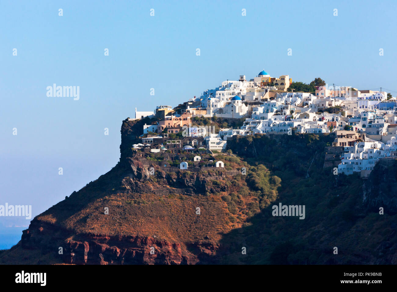 Houses perched on the cliff on the coast of Aegean Sea, Santorini Island, Greece Stock Photo