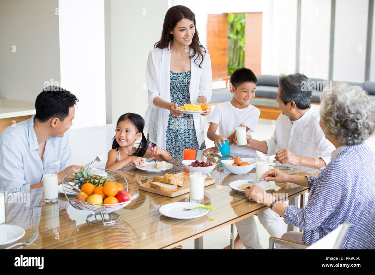 Happy family having breakfast Stock Photo - Alamy