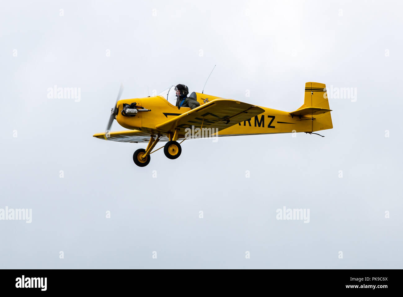 A bright yellow Tiger Club D31 Turbulent single seater in level flight during an air display Stock Photo