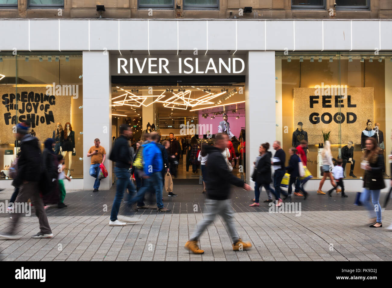 walking past a River Island store in Church St Stock Photo - Alamy