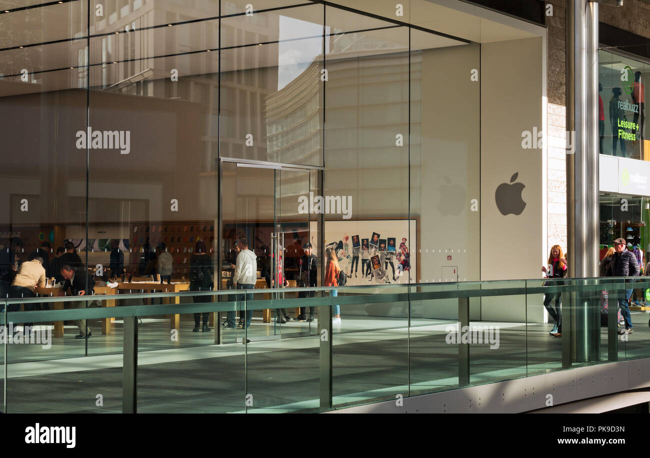 People inside browsing the products at the Apple store in Liverpool One shopping complex. Stock Photo