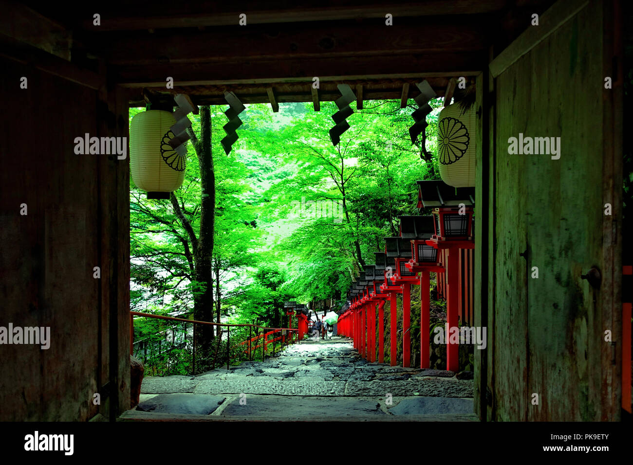 Steep stairs, Red Light Poles continued staircase entrance to Kibune-jinja shrine, Kyoto, Japan. When  the scene back down. Sective focus. Stock Photo