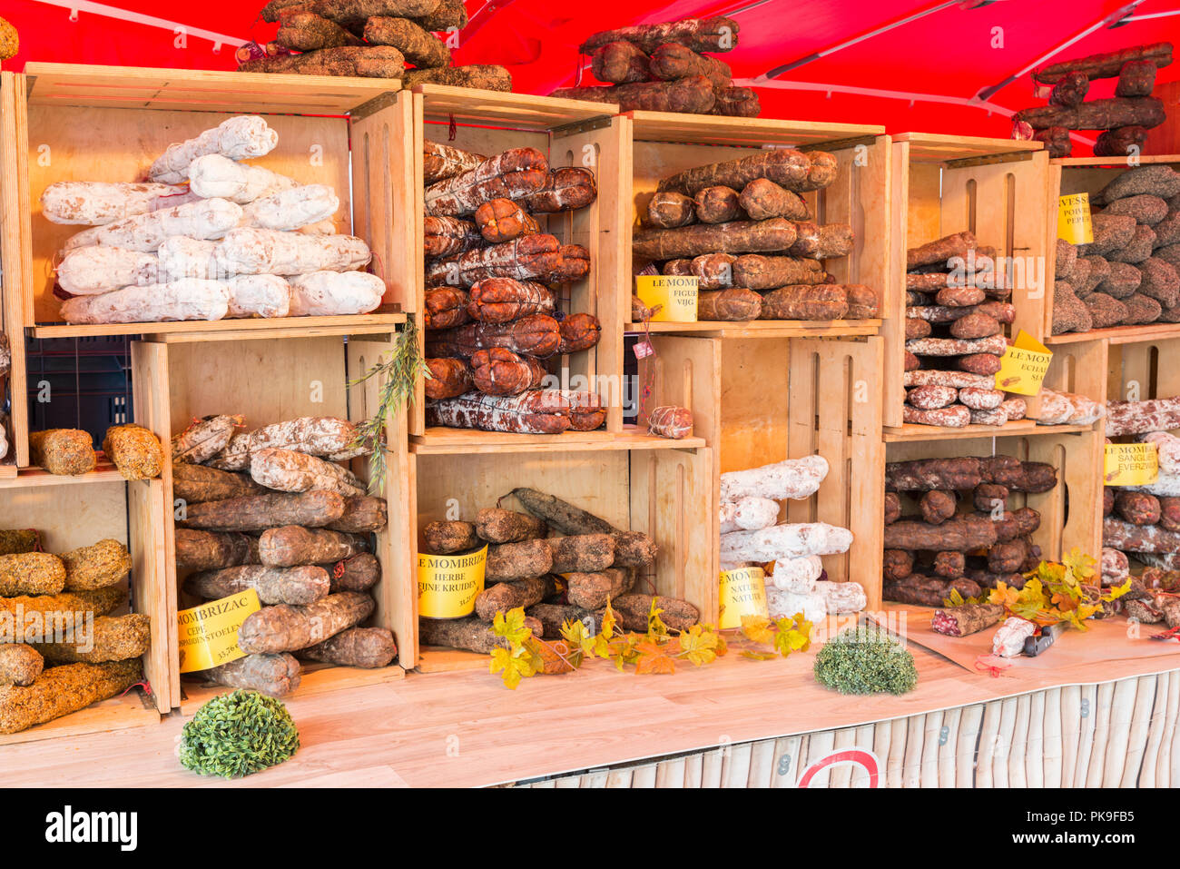 Malmedy,Belgium,15-august-2018: a market stall with various types of hard sausage, neatly displayed in wooden crates,the sausage are a specialty from belgian ardennes Stock Photo