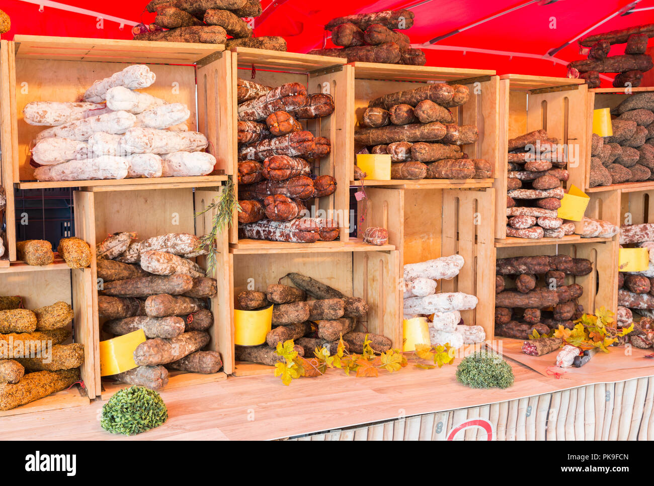 Malmedy,Belgium,15-august-2018: a market stall with various types of hard sausage, neatly displayed in wooden crates,the sausage are a specialty from belgian ardennes Stock Photo