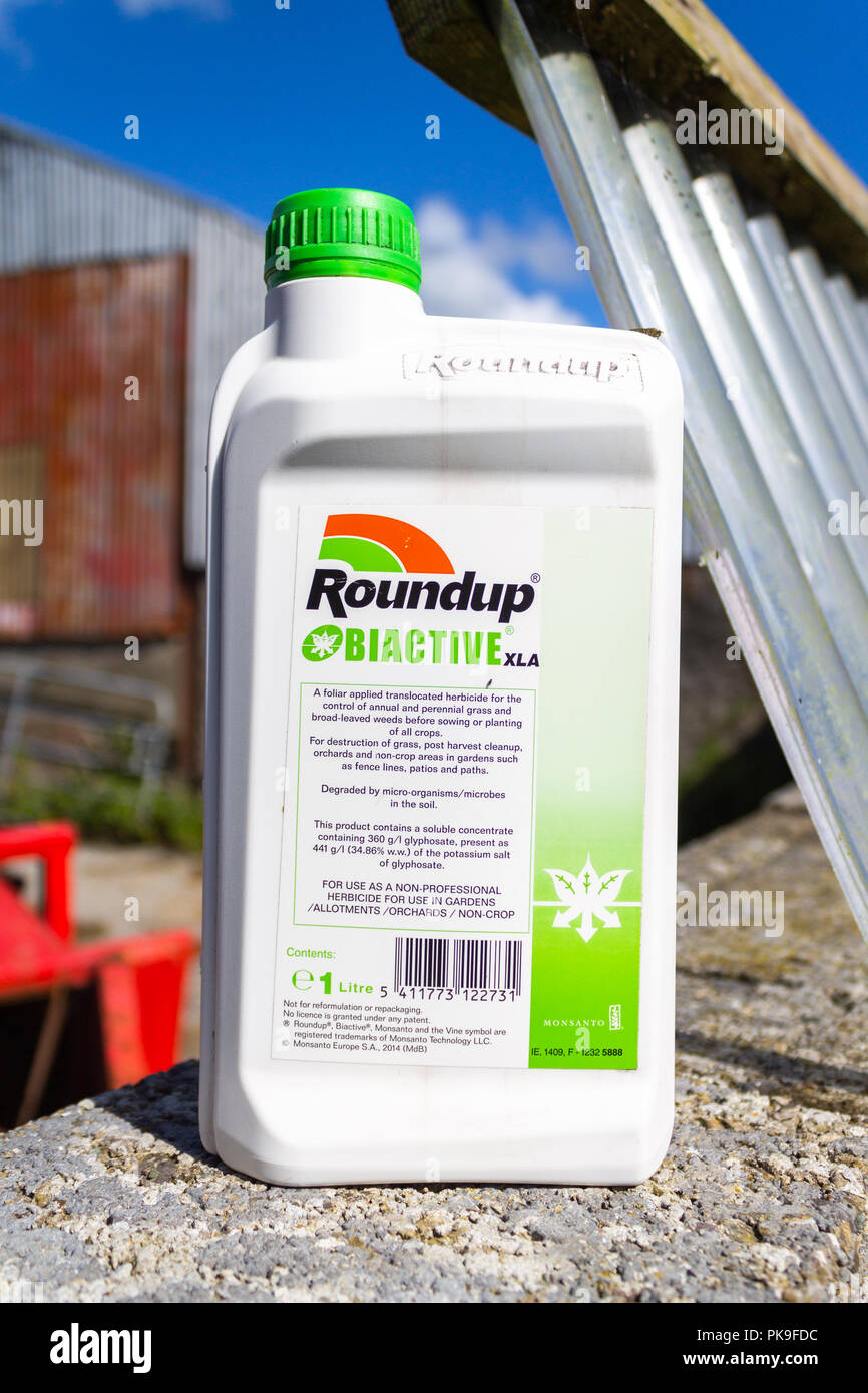 Roundup or glyphosate concentrated weedkiller or weed killer in a plastic measuring bottle Stock Photo