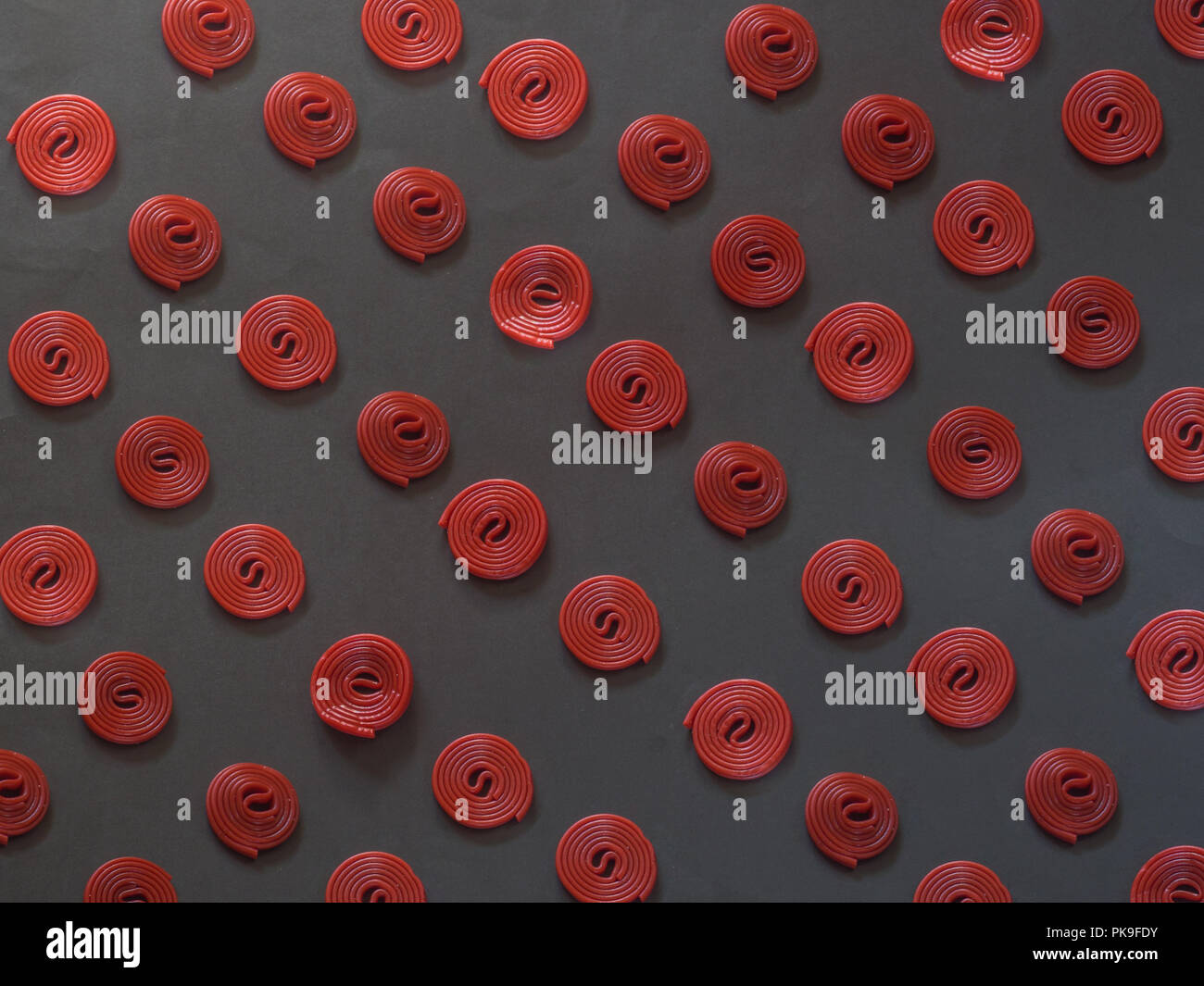 Licorice pattern on black background Stock Photo - Alamy