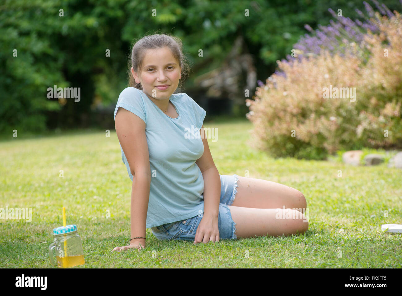 a portrait of smiling teenager lying in the grass Stock Photo - Alamy