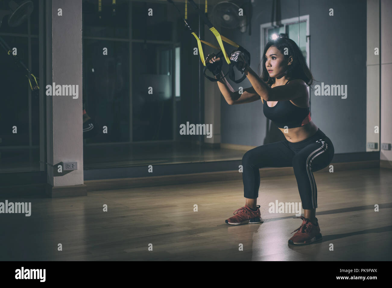 Strong woman doing trx exercise with straps in the fitness gym Stock ...