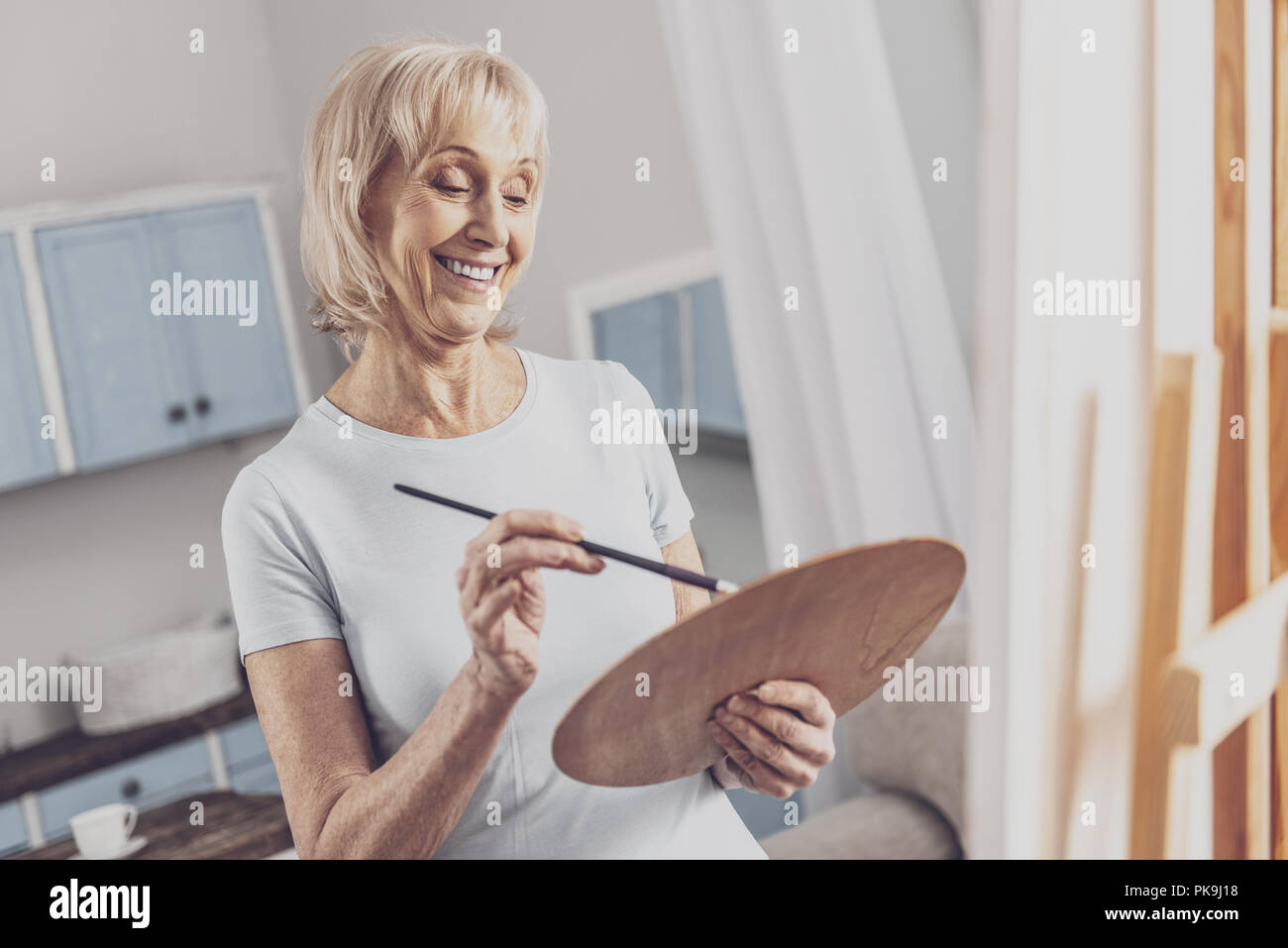 Professional artist holding color palette while drawing Stock Photo
