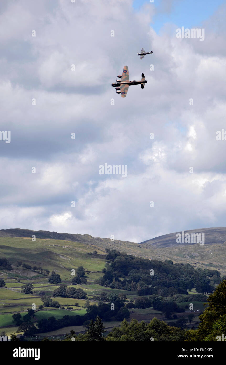 Lancaster Bomber and Spitfire of the Battle of Britain Memorial Flight over Windermere fells. Stock Photo