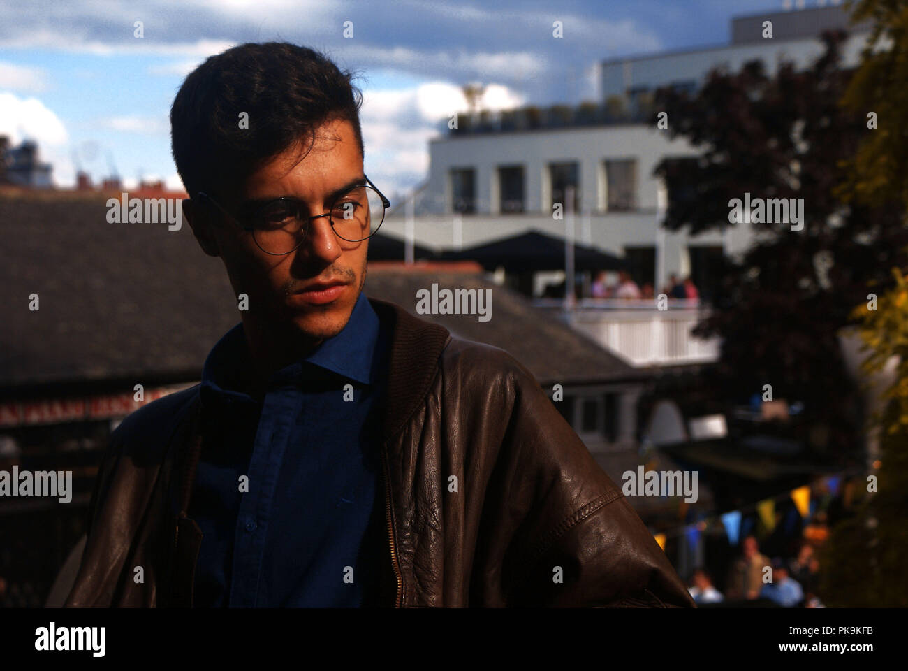 Portrait of a young spanish man with intellectual rounded glasses