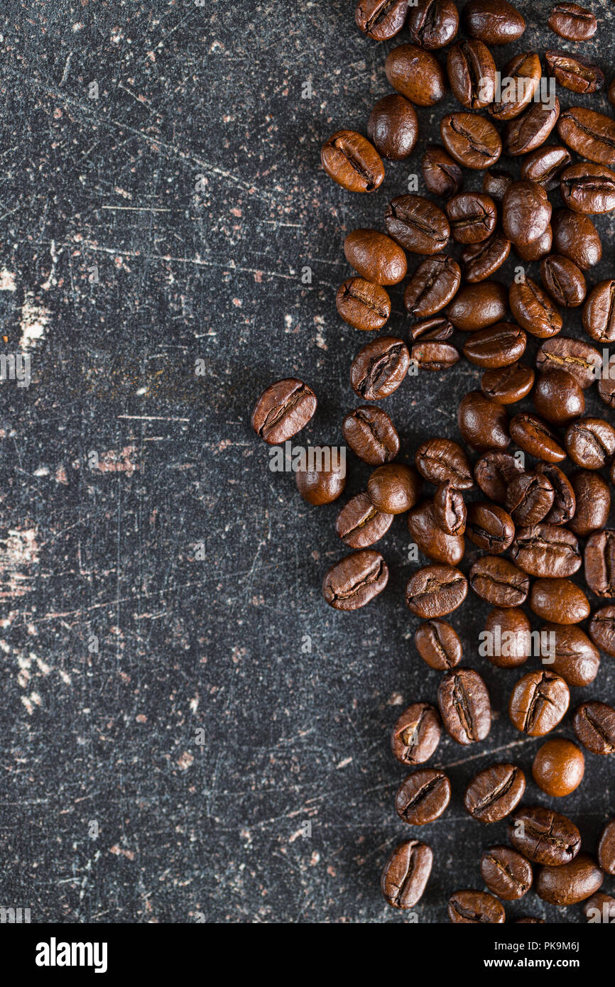 Roasted coffee beans on old kitchen table. Stock Photo