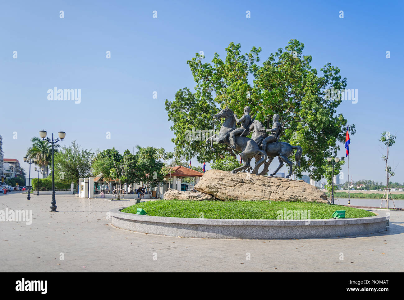 Phnom Penh, Cambodia - April 9, 2018: View of the Preah Sisowath Quay with the horse monument to the warriors Techo Meas and Techo Yot and flags Stock Photo