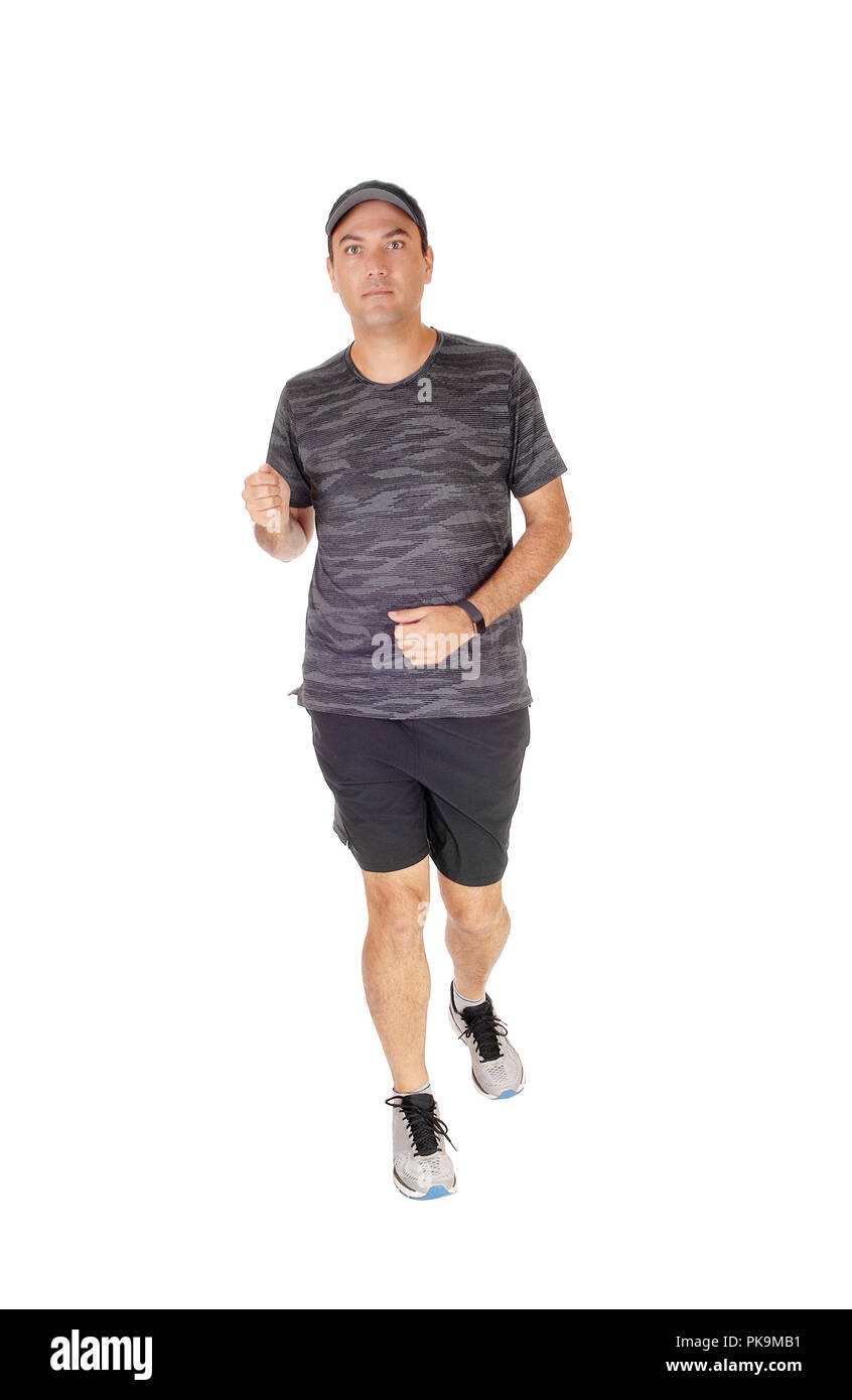A tall handsome young man in sports outfit and running shoos running  in the studio, isolated for white background Stock Photo
