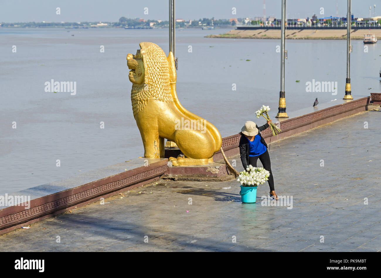 Phnom Penh, Cambodia - April 9, 2018: Preah Sisowath Quay, a riverside public promenade along the banks of the Mekong and Tonle Sap rivers with a guar Stock Photo