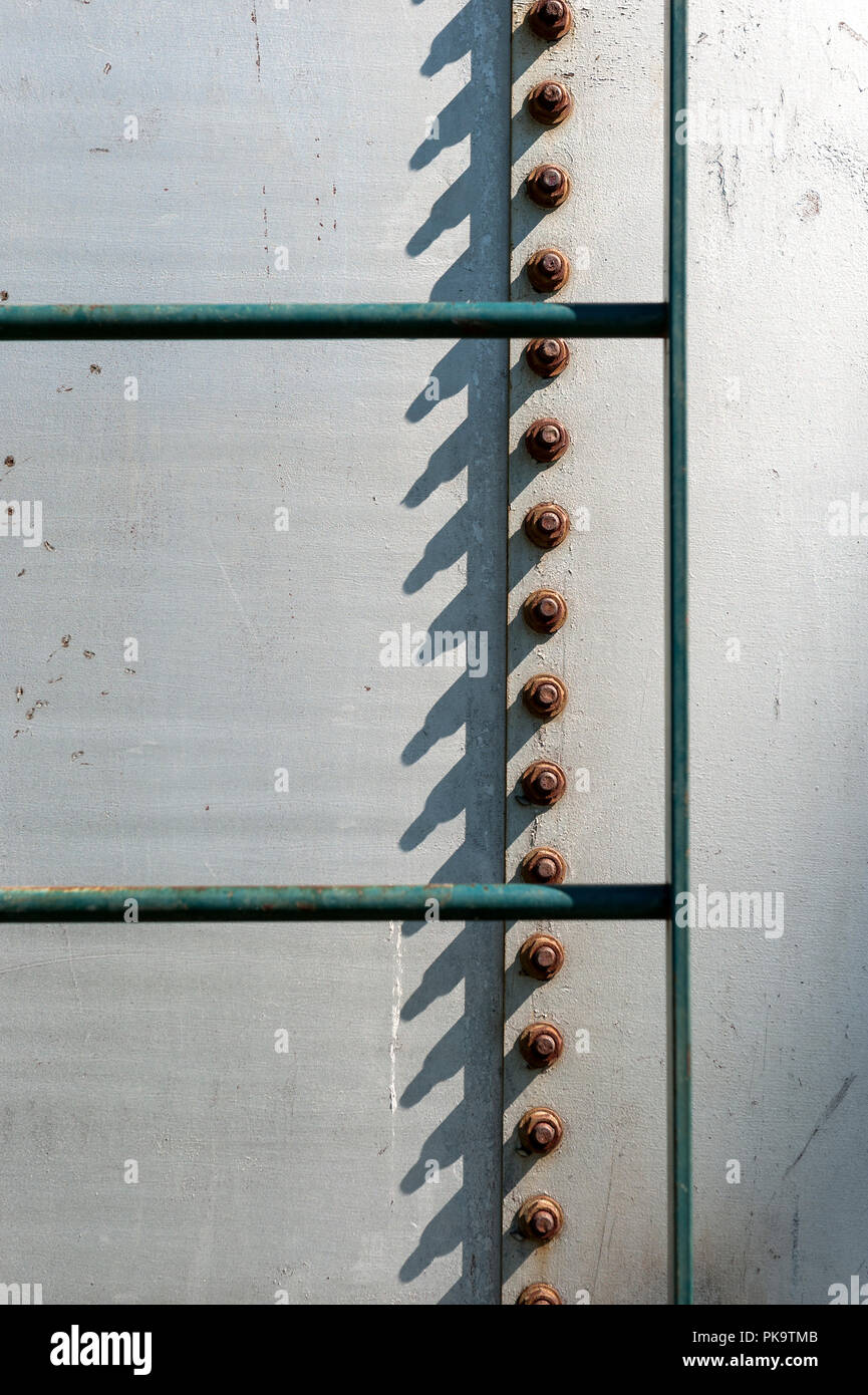rusting metal bolts/screws on a silo Stock Photo