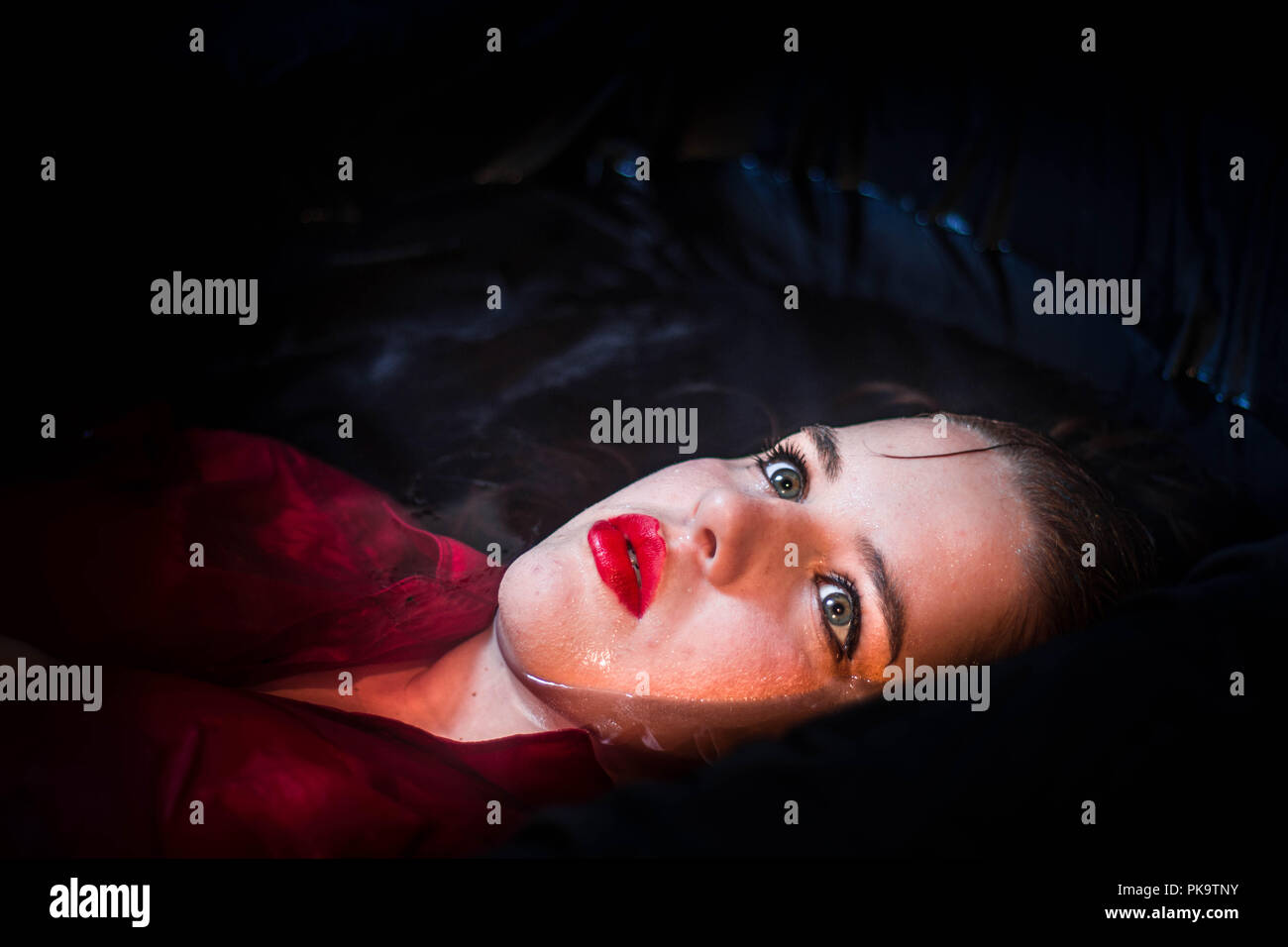 Close up portrait of a beautiful young woman blue eyes red lips ...
