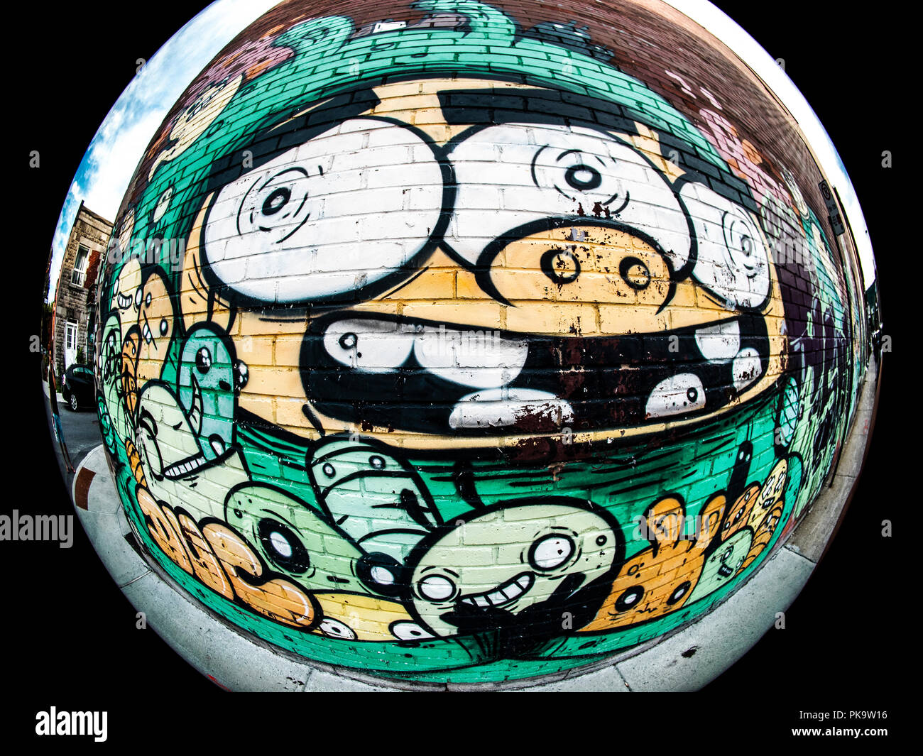 strange and weird graffiti in Montreal alley, street art, taken with circular fisheye colorful cool and vibrant color Stock Photo