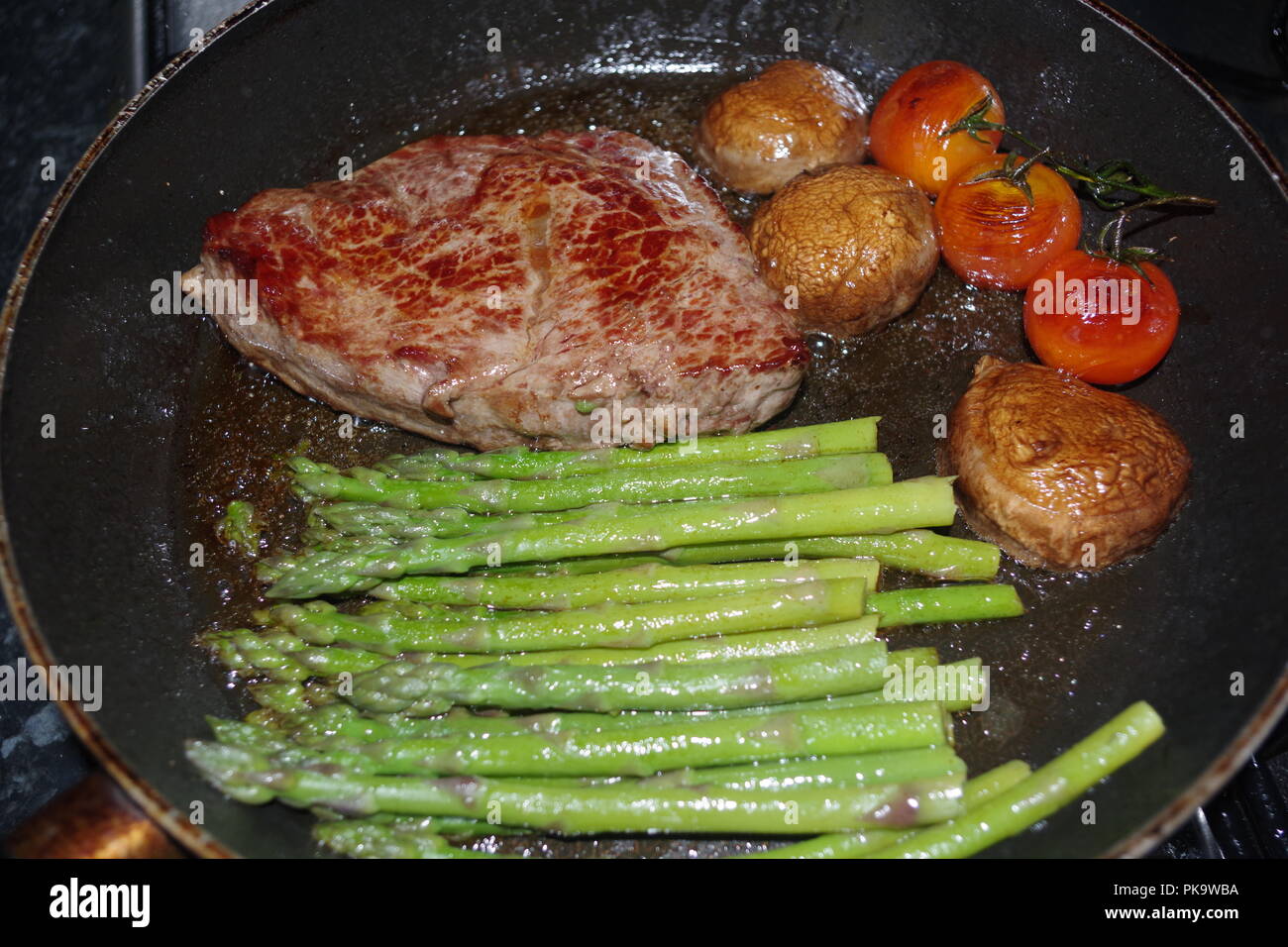Steak Dinner Frying in a Pan. Home Cooking, UK Stock Photo Alamy