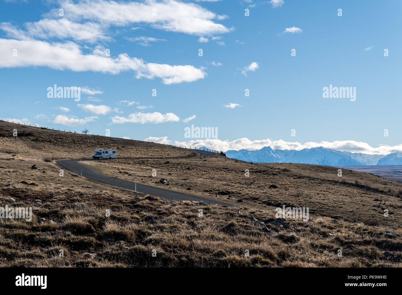 Camper van driving down mountain road in New Zealand Stock Photo