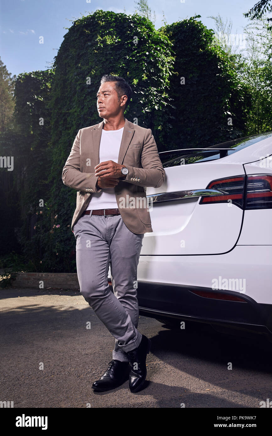 Mature man standing beside the car Stock Photo - Alamy