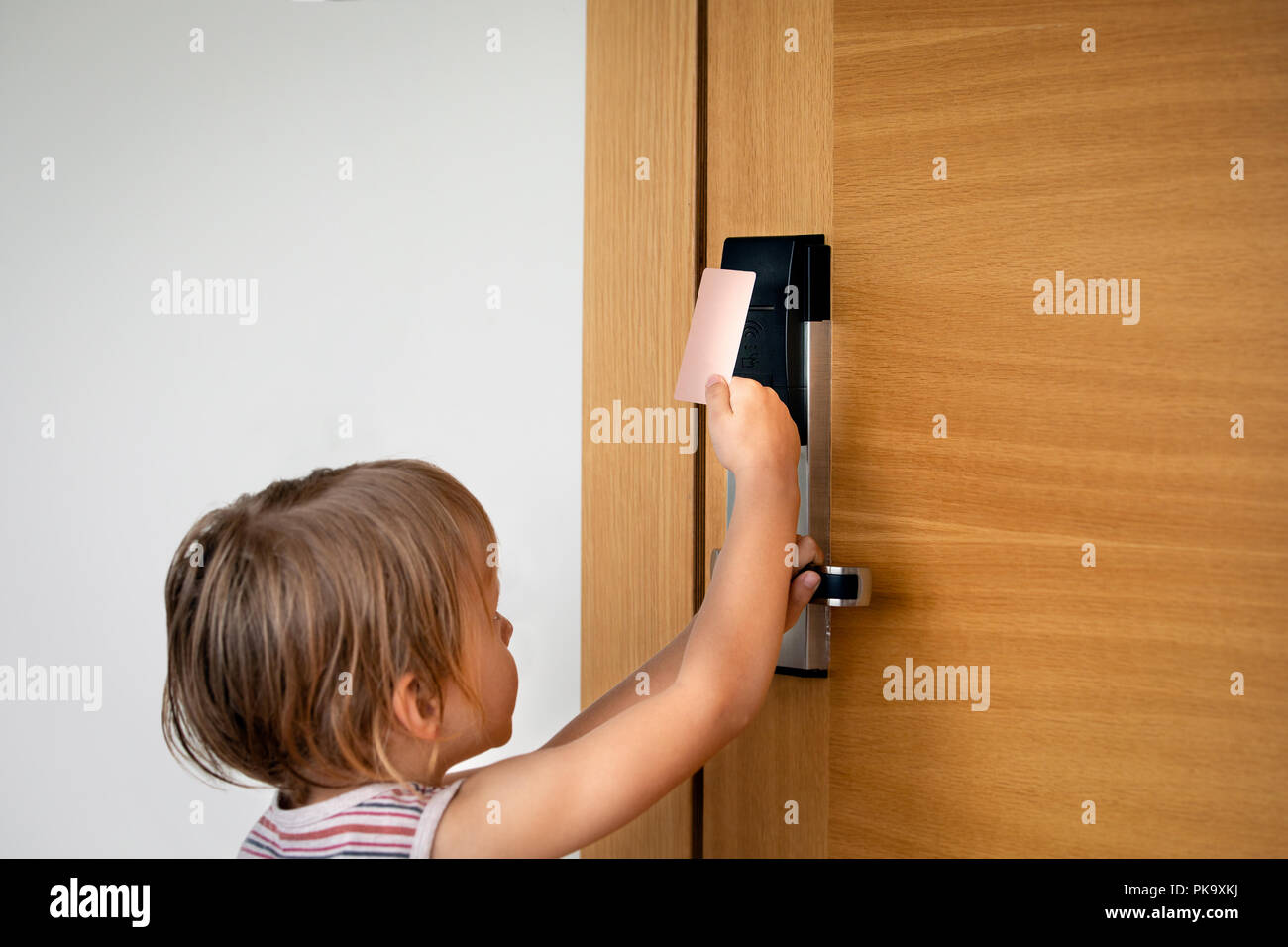 Little Boy Trying To Open Doors With Card Lock At The Hotel