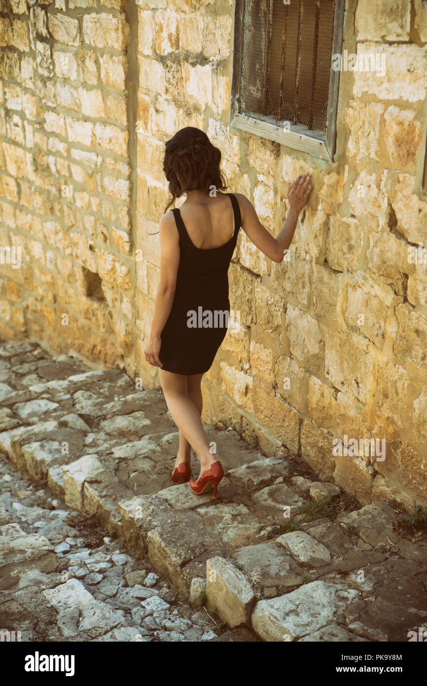 Rear view of a woman walking down the steps Stock Photo