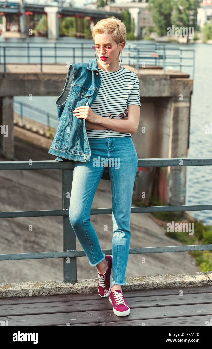 Beautiful woman wearing jeans standing in the street Stock Photo - Alamy
