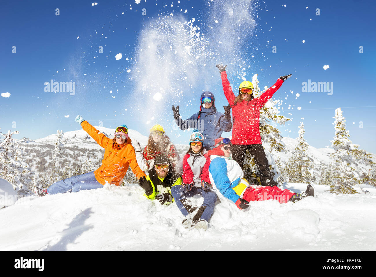 Happy skiers and snowboarders having fun at ski resort. Winter vacations concept Stock Photo