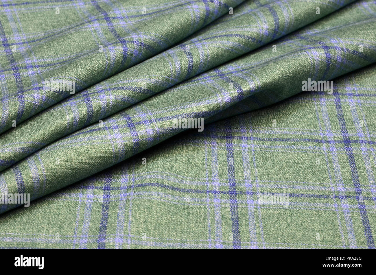 Woolen suit fabric, blue cage on green Stock Photo