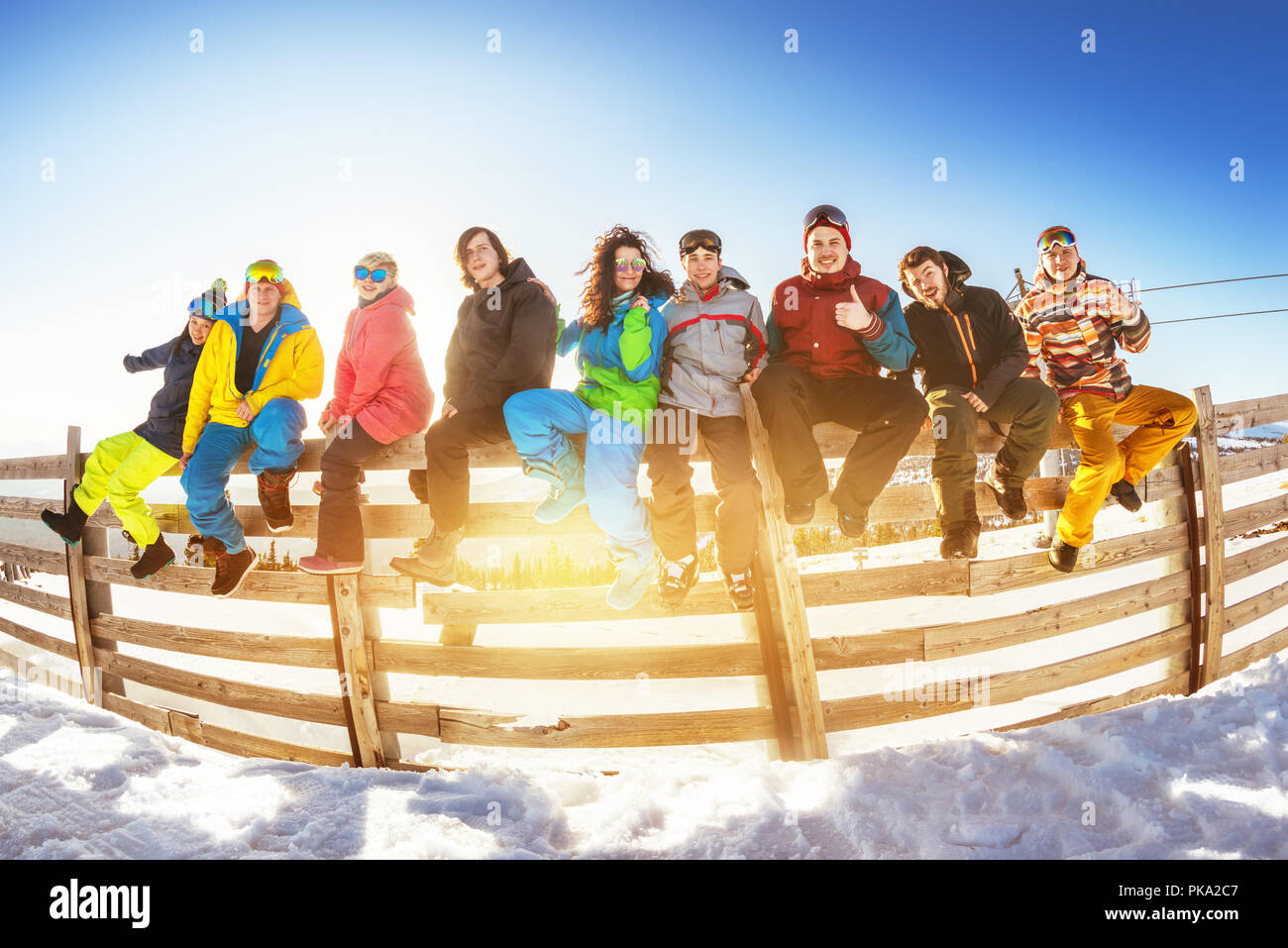 Group of friends at ski resort. Winter vacations concept with group of skiers and snowboarders Stock Photo