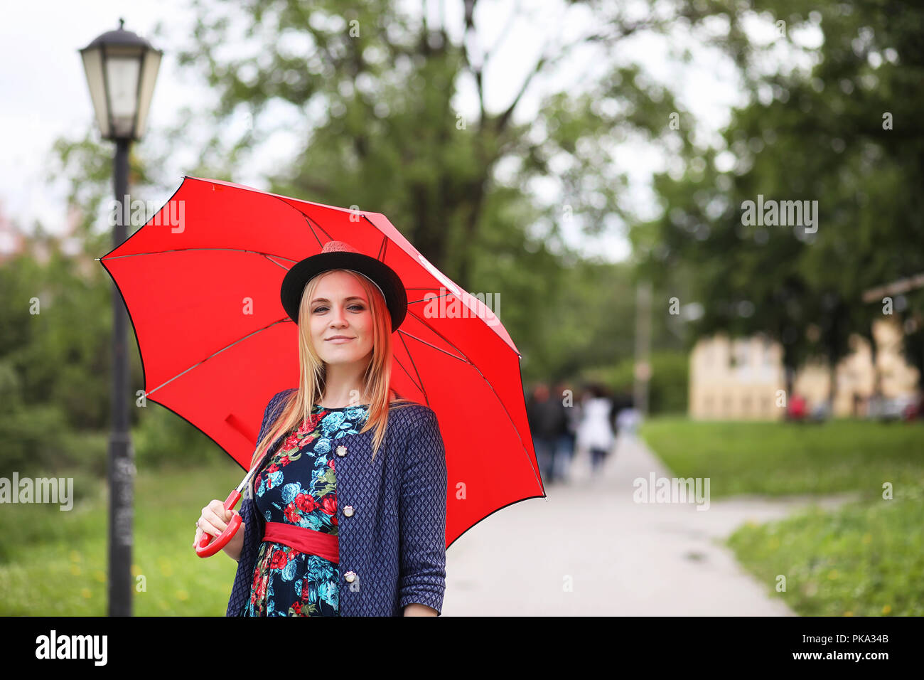 Girl in the street with an umbrella Stock Photo - Alamy