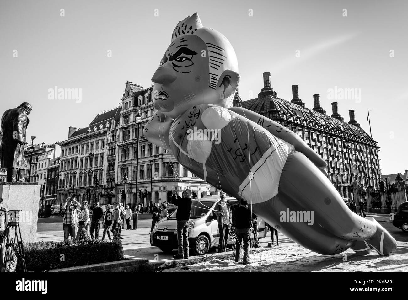 Protesters Fly a 29ft Long Bikini-Clad Blimp of London Mayor Sadiq Khan Over Parliament Square, London, UK Stock Photo