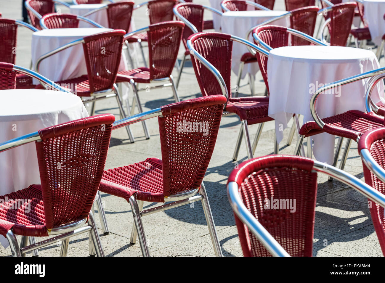 Rows of tables and chairs on the street in a restaurant Stock Photo - Alamy