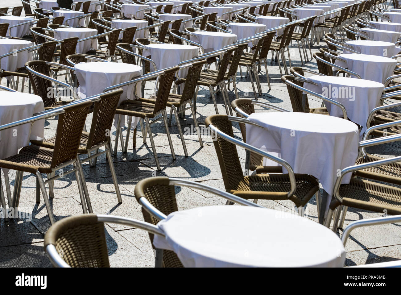 Rows of tables and chairs on the street in a restaurant Stock Photo - Alamy