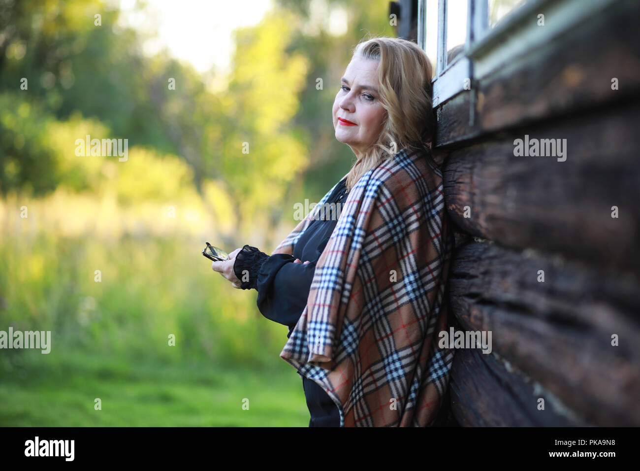 An elderly woman on the porch of a house Stock Photo - Alamy