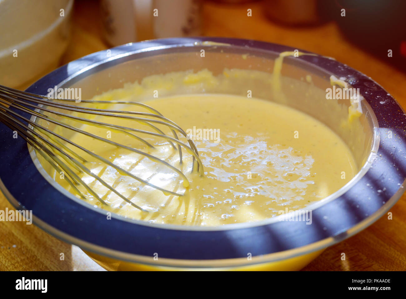 Mixing butter and sugar in bowl with mixing machine, making bakery Stock Photo