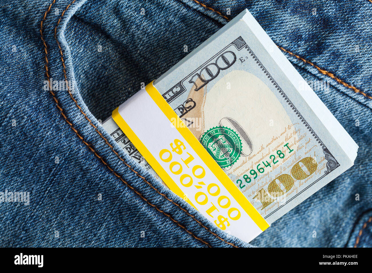 Ten Thousand Dollars Stuffed in Pants Pockets. Stock Photo