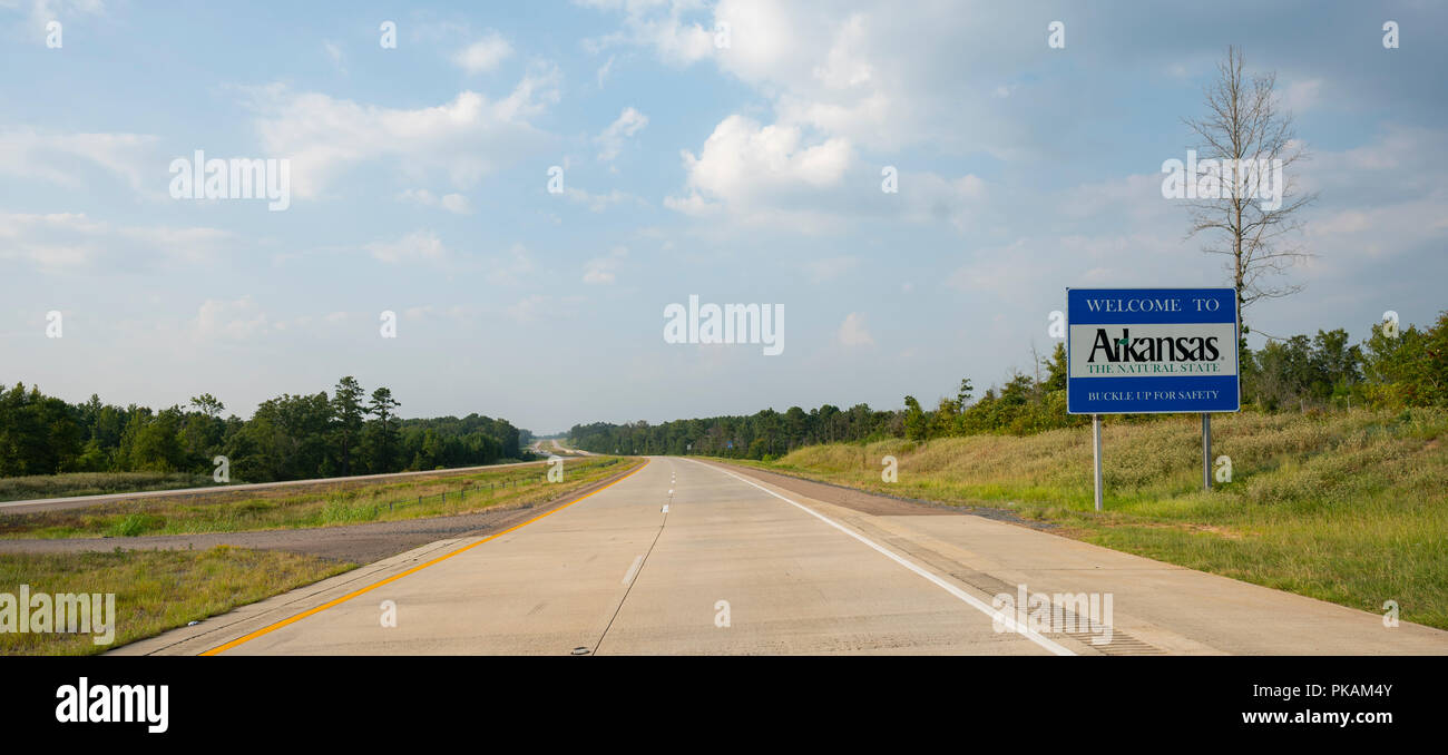 The road sign indicates you are entering Arkansas the natural state Stock Photo