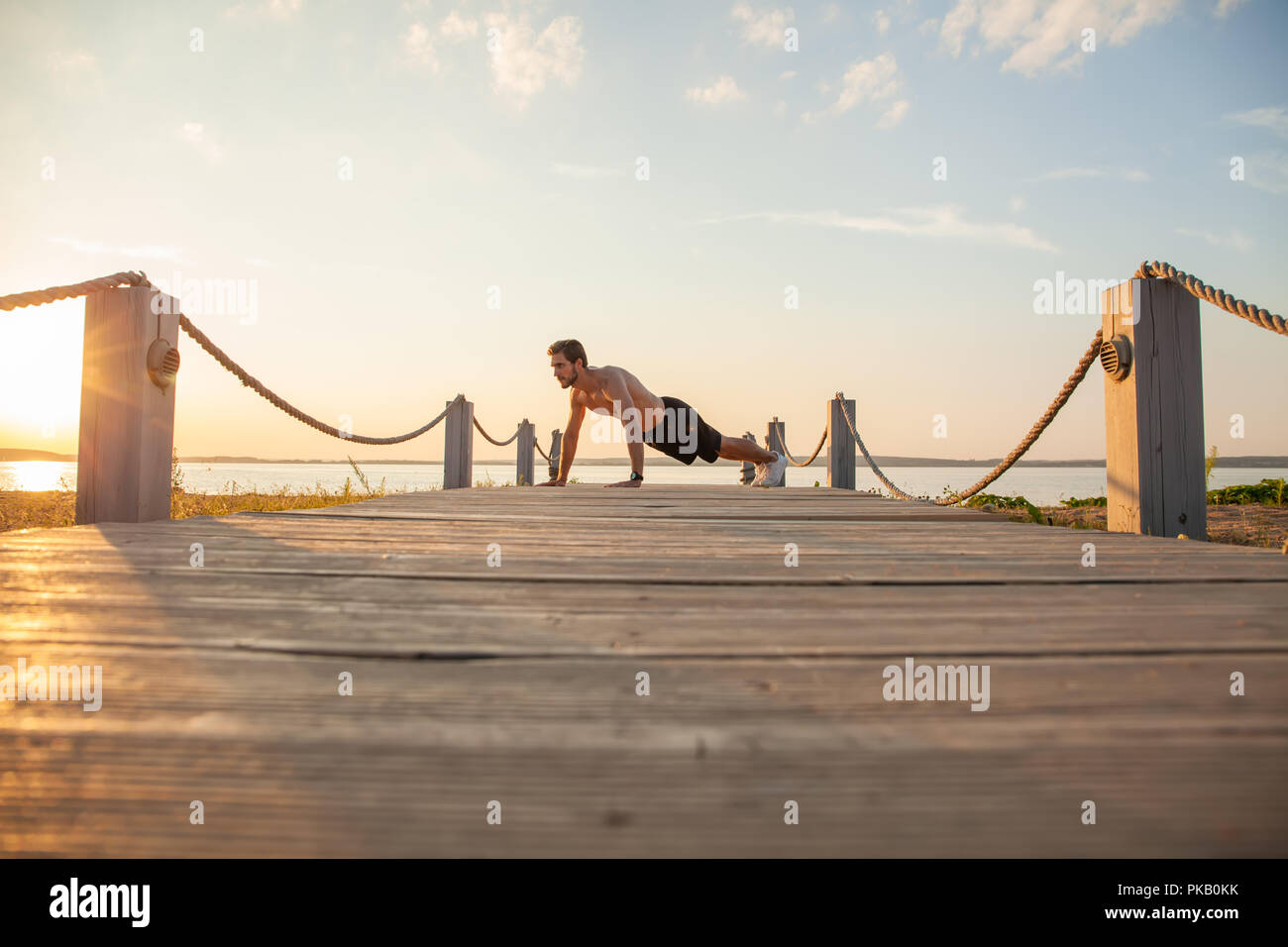 Picture of a young athletic man doing push ups outdoors Stock Photo - Alamy