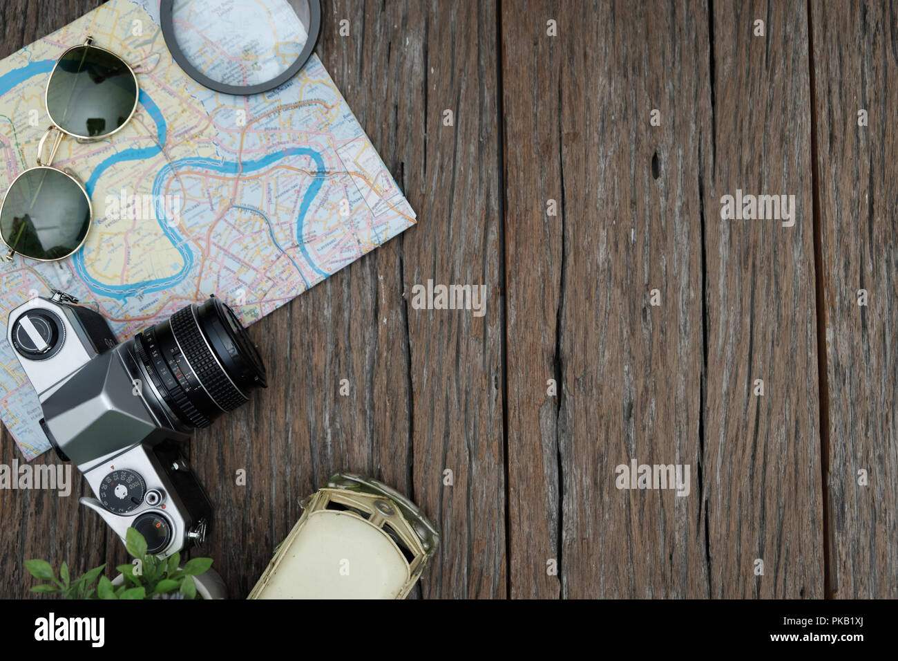 Topview of retro travel equipment on a wooden table. Vintage